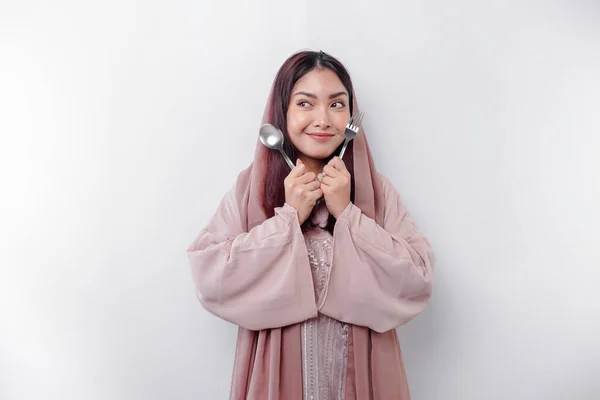 Asian Muslim Woman Fasting Hungry Holding Cutlery While Looking Aside — Stock Photo, Image