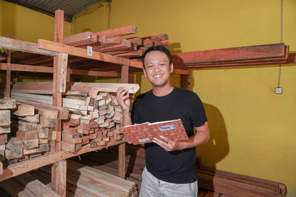 stock image Handsome Asian Man is smiling while checking his carpentry workshop