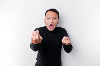 The angry and mad face of Asian man in black shirt isolated white background.