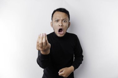 The angry and mad face of Asian man in black shirt isolated white background.