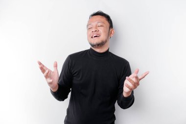 Siyah tişört giyen genç Asyalı bir adam izole edilmiş beyaz arka planda gülümserken bir fikir sunuyor.