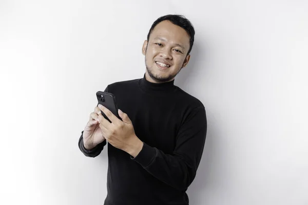 Excited Asian Man Wearing Black Shirt Smiling While Holding His — Stockfoto