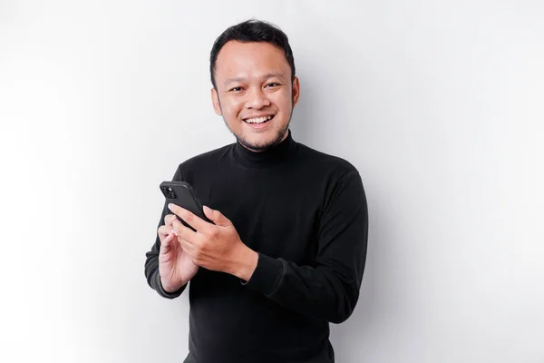 Excited Asian Man Wearing Black Shirt Smiling While Holding His — Stockfoto
