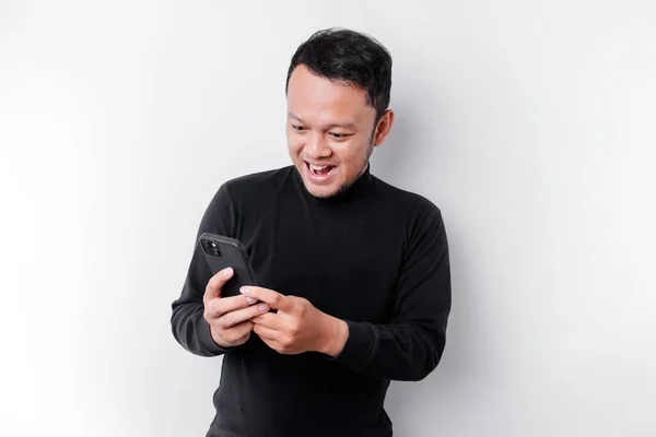 Excited Asian Man Wearing Black Shirt Smiling While Holding His — Stock Photo, Image