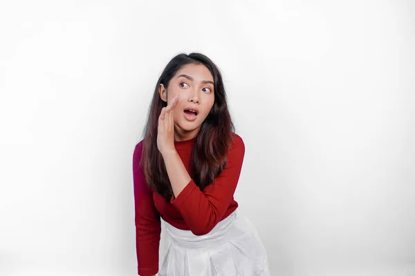 stock image Young beautiful woman wearing a red top shouting and screaming loud with a hand on her mouth. communication concept.