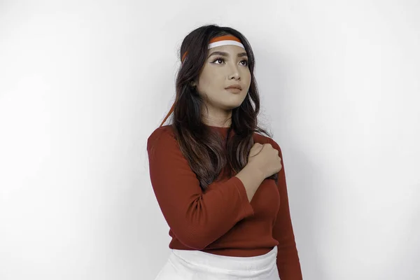 stock image Beautiful Asian woman giving salute celebrate Indonesian independence day on August 17 isolated over white background