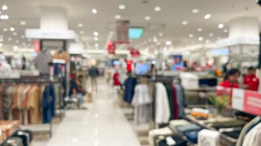 Abstract blurred of fashion clothes shop boutique interior in a shopping mall, with bokeh light background. clipart