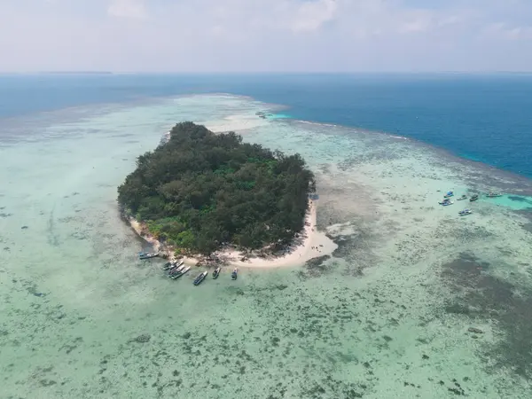Aerial view of remote island in Karimunjawa Islands, Jepara, Indonesia. Coral reefs, white sand beaches. Top tourist destination, best diving snorkelling.