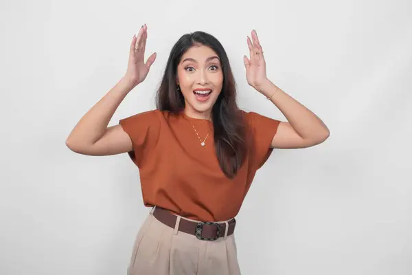 Excited Surprised Young Asian Woman Wearing Brown Shirt Standing Isolated - Stok İmaj