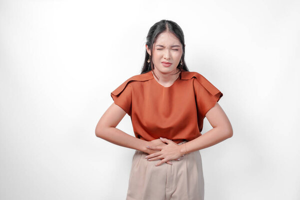 Unwell Sick Ill Asian Woman Brown Shirt Holding Her Stomach Stock Picture