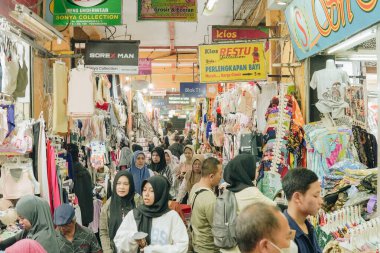 The atmosphere of the Beringharjo Malioboro traditional market in Yogyakarta, Indonesia. Selling batik clothes and fabric textiles.
