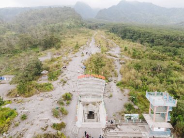 Aerial view of Bunker Kaliadem, abandoned concrete shelter with views of the active Merapi volcano, Yogyakarta, Indonesia. clipart