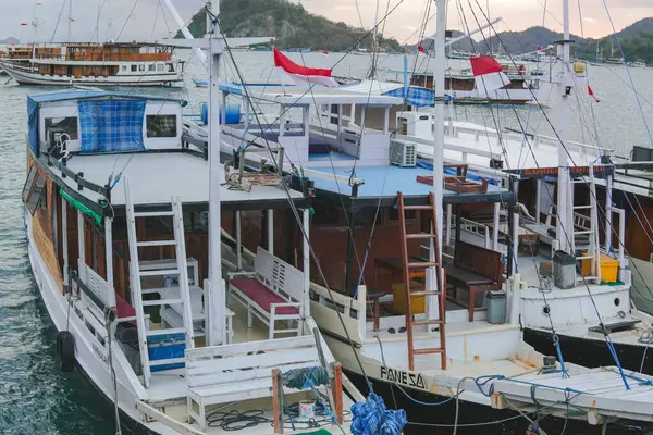 Beautiful seascape of Labuan Bajo filled with a collection of traditional boats Pinisi schooner sailing on the ocean.