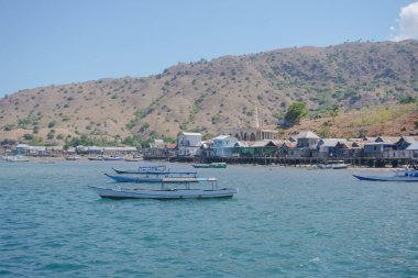 Scenery of Komodo island in the middle of the sea in Labuan Bajo, Indonesia, with boat sailing.