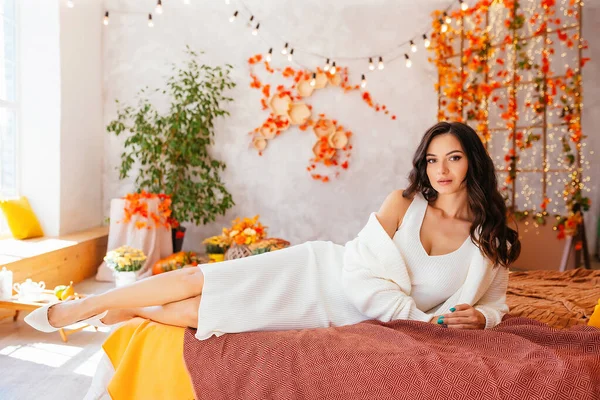 stock image A young girl in autumn, in a white dress and jacket in autumn scenery with long loose hair curls. High quality photo