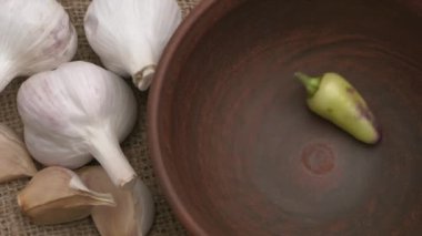 Renkli biberler ve aromatik sarımsak karanfilleri titizlikle sade bir ortamda düzenlenir.