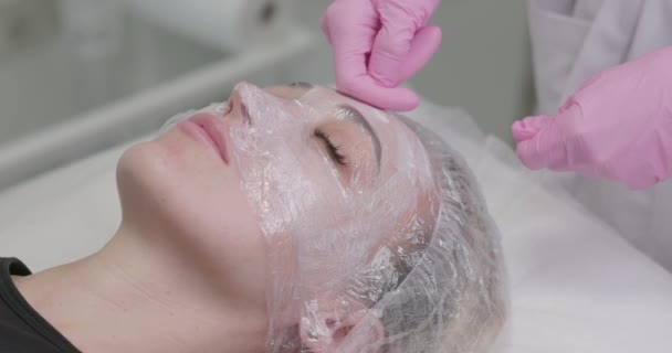 Kosmetolog Applicerar Närande Mask Ung Kvinna Spasalong Närbild Kvinna Som — Stockvideo