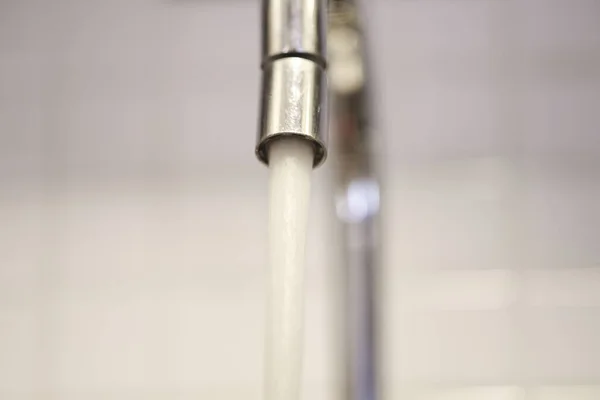 stock image An open kitchen sink faucet leaking water.