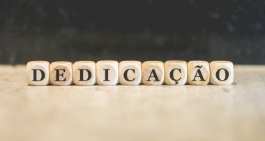 Brezilya Portekizcesi tahtadan küplere yazılmış DEDICATION yazıları. Siyah arkaplan. 