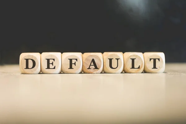 stock image Inscription DEFAULT written on wooden cubes. Black background. 