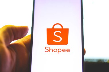 Brasilia, Federal District, Brazil - April, 2023. Shopee app logo on a smartphone screen clipart