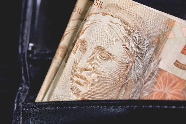 Brazilian Real notes inside a wallet. Brazilian economy and finance.