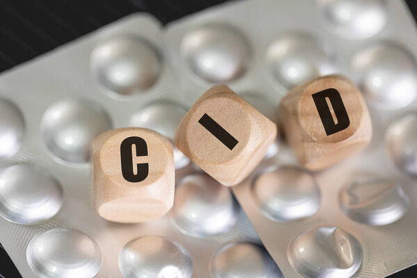 The abbreviation ICD for International Classification of Diseases written on wooden dice in the Brazilian Portuguese language. Health, Medicine, Sick, Patient