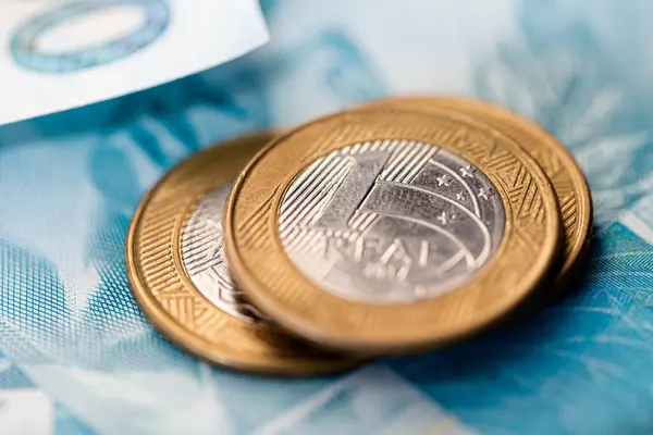 stock image Heap of Brazilian Real banknotes and coins, closeup on table