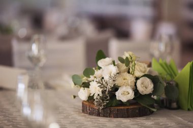 Ziyafet. Misafirler için düğün masası, çatal bıçak takımı, çiçekler ve masa örtüsüyle kaplı. Pastel tonlarında klasik bir düğün için şık bir düğün dekoru. Düğün günü masadaki güzel çiçekler.