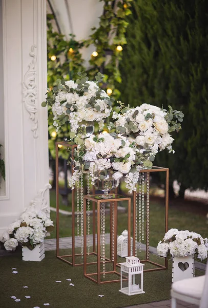 the wedding ceremony in the open air of fresh flowers, with candles. gentle and beautiful wedding decor for newlyweds. Big and beautiful bouquet of blossom flowers from a variety of greenery.