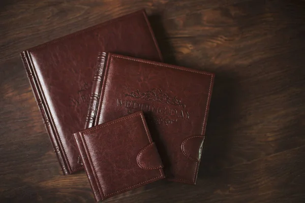 Wedding photobooks in brown leather binding. Wedding photo book, album family album. Photo books with embossing and a cover of genuine leather. Services of a professional photographer and designer.