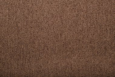Kahverengi kumaş. Doğal keten dokusu. Açık kahverengi kabarık kumaş. Kare yakın çekim, üst manzara. Tuvalin arka planı. Doğal pamuk çuval bezi. Klasik tekstil arka planı. Eski keten kumaş..