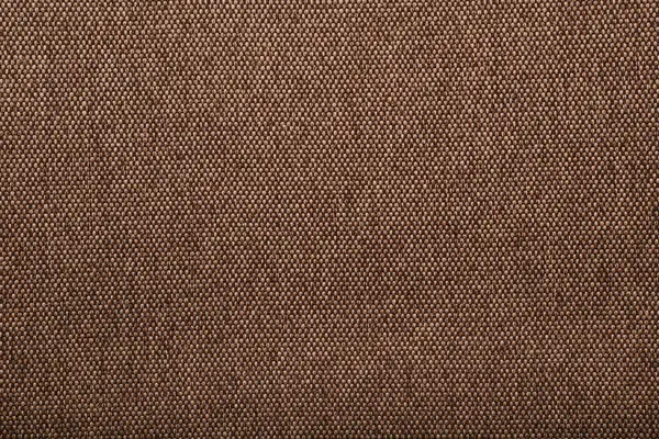 Brown fabric texture. Natural linen texture. Light brown coarse fabric. Square closeup fragment, top view. Canvas background. natural cotton burlap. Vintage textile backdrop. Old flax fabric.