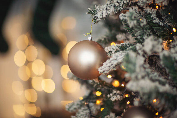 Christmas decorations, background blur. Christmas decorations on the holiday tree. Many balls garland glowing lamps on the branches. Christmas and New Year ornament. Christmas beautiful lights bokeh.