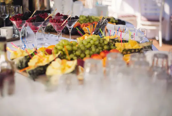 Buffet reception fruit, wines, champagne.fruit plate on wedding table. catering canape assorted fresh fruits, berries and citrus. Fruits for the holidays. Restaurant service at the event.