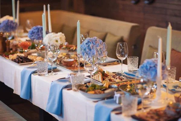Beautiful decorated table set for wedding party. Wedding/Baby shower decorations with flowers. Background of decorated party table with selective focus. Decor and food on luxury celebration.
