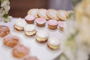 Delicious sweet buffet with cupcakes. Sweet holiday buffet with cupcakes and other desserts. Candy Bar. Dessert table for party goodies. Party reception, decorated delicious in the restaurant.