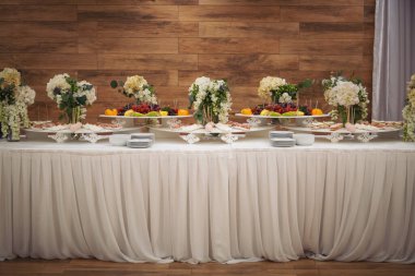 Delicious sweet buffet with cupcakes. Sweet holiday buffet with cupcakes and other desserts. Candy Bar. Dessert table for party goodies. Party reception, decorated delicious in the restaurant.