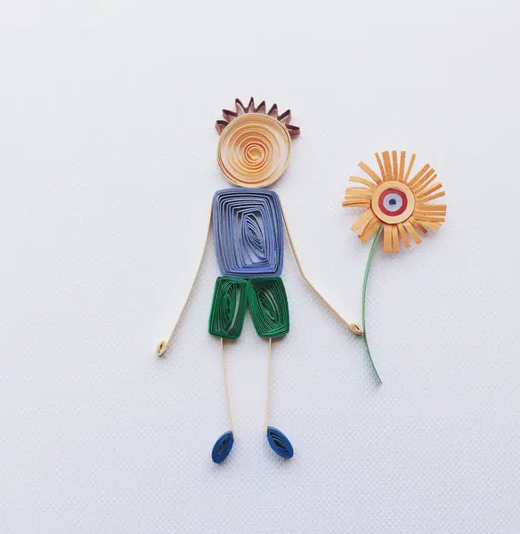 Simple colorful stick figure boy giving flower, love, Mother\'s Day, boy with blue shirt make in quilling art isolated on white background. Hand made of paper quilling technique. handicraft at home.