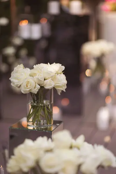 View of elegant expansive white flowers and candles decoration for wedding party. the wedding ceremony in the open air of fresh flowers, with candles. Luxury and beautiful wedding decor. Decor details.