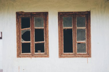 Terk edilmiş kırık camlar. Eski yıkılmış evler. Pencerede kırık cam var. Savaş, yıkım, yeniden yapılanma. Terk edilmiş, işe yaramaz evler. Sosyal ve ekonomik sorunların sonuçları. Boş ev