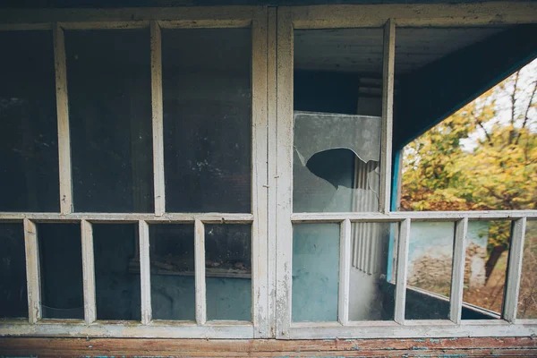 an abandoned broken windows. Old destroyed houses. Broken glass in the window. War, destruction, restructuring. abandoned, useless houses. Consequences of social and economy problems. Empty house