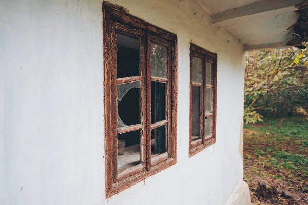 an abandoned broken windows. Old destroyed houses. Broken glass in the window. War, destruction, restructuring. abandoned, useless houses. Consequences of social and economy problems. Empty house