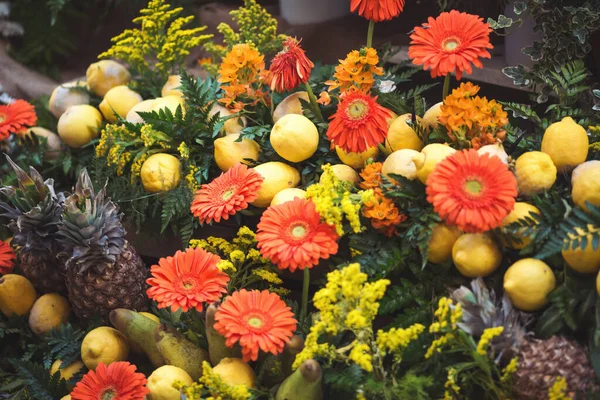 Colourful fruit and flowers. Composition of fruits, herbs and flowers are the symbol of summer.