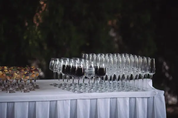 buffet at the wedding Banquet. A glasses with drink arranged on a table in the restaurant, cafe, or bar. Preparation for the birthday, wedding, or any celebration day.