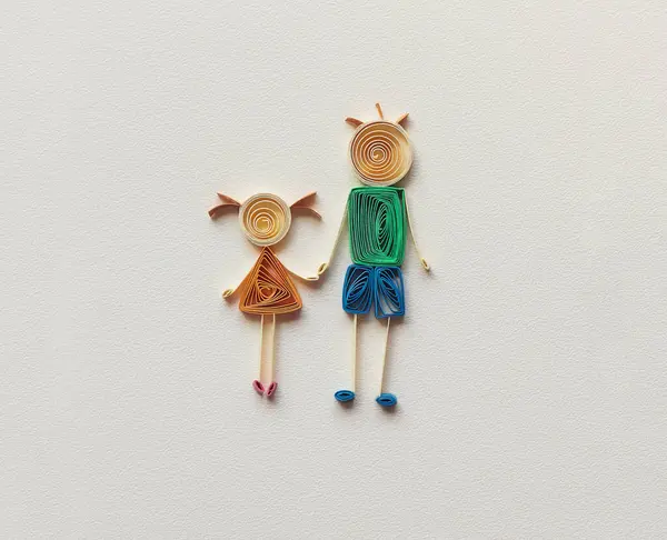 Happy family with father and daughter holding hands together. family stick figure. parents and children. Hand made of paper quilling technique. handicraft at home, card craft, Business concept.