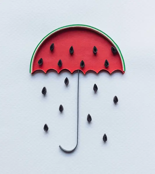 watermelon umbrella with rain of seeds. Symbol of summer and fresh fruits. Creative paper cut and craft about Lovely day.Hand made of paper quilling technique. handicraft at home, card craft, Business