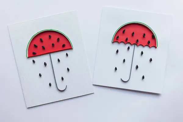 cards with watermelon umbrella with rain of seeds. Symbol of summer and fresh fruits. Creative paper cut and craft about Lovely day.Hand made of paper quilling technique. handicraft at home,card craft