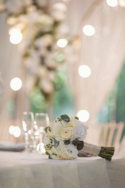 Düğün için bir buket gül. Klasik ve zarif bir gelin süsü. Restorandaki düğün buketini kapat.. 