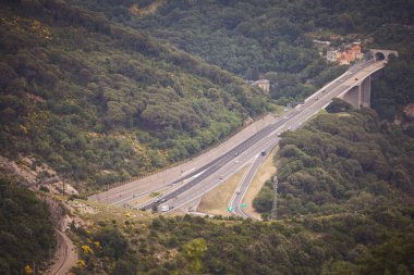İtalya, Ceneviz. Tüneli ve köprüsü olan bir otobanın parçası. Genova est. İtalya 'da otoban boyunca giden arabalar bir tünelden geçiyor.